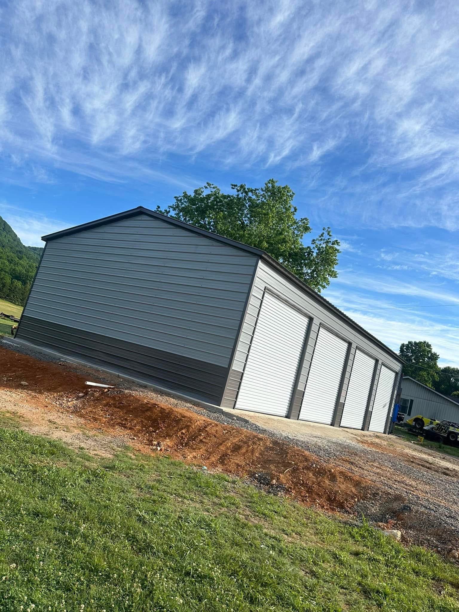 Large four-bay metal building on a graded lot