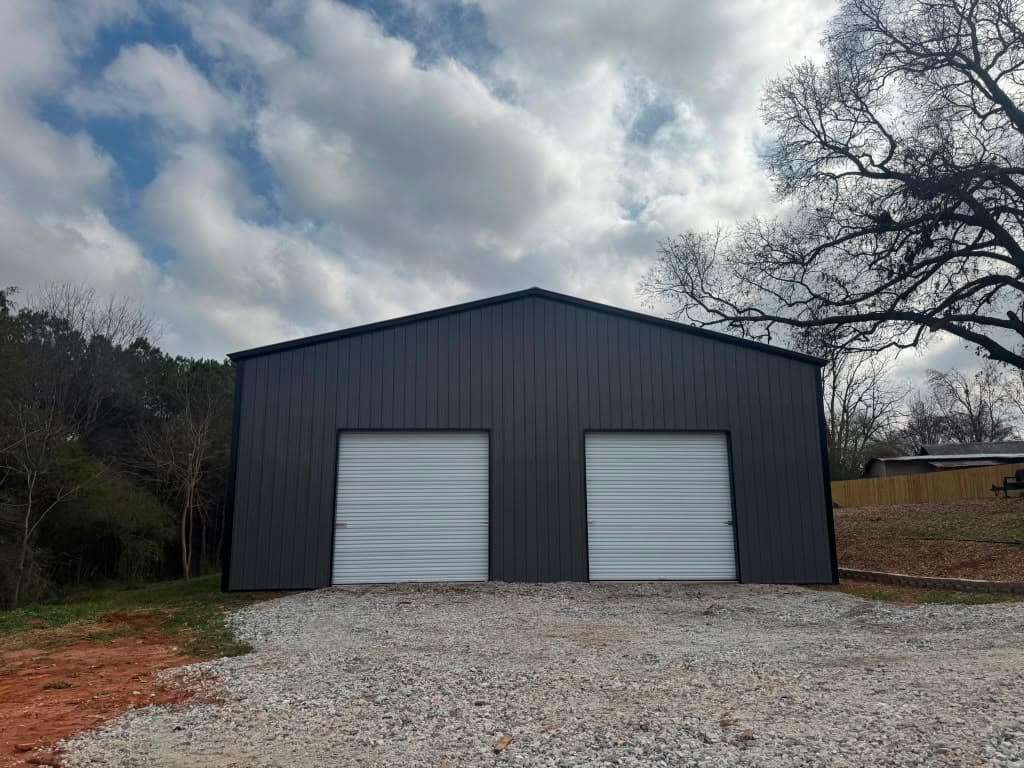 Black 30x80x14 metal garage with two roll-up doors — front view